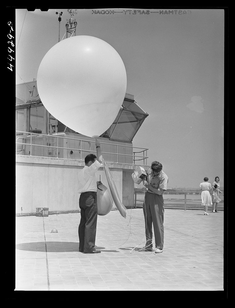 Weather Bureau men preparing to send up the balloon for weather data. Municipal airport, Washington, D.C.. Sourced from the…