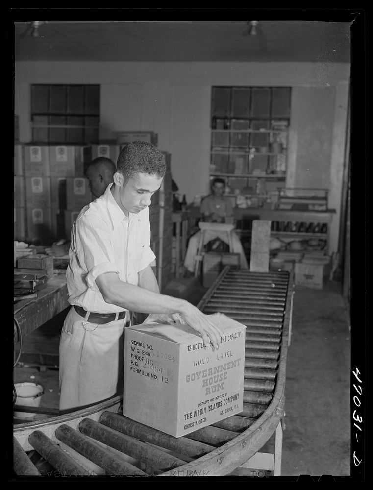 Christiansted, Saint Croix Island, Virgin Islands (vicinity). Packing bottles of rum for shipment at the Virgin Islands…