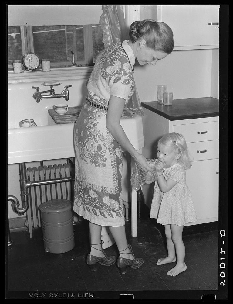 Mrs. Betty Zimmerman and child in kitchen of new home at Greenbelt, Maryland. Sourced from the Library of Congress.
