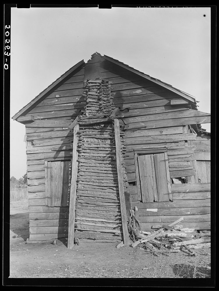 Side view of  family's home, showing mud chimney. Near Savannah, Georgia. Sourced from the Library of Congress.