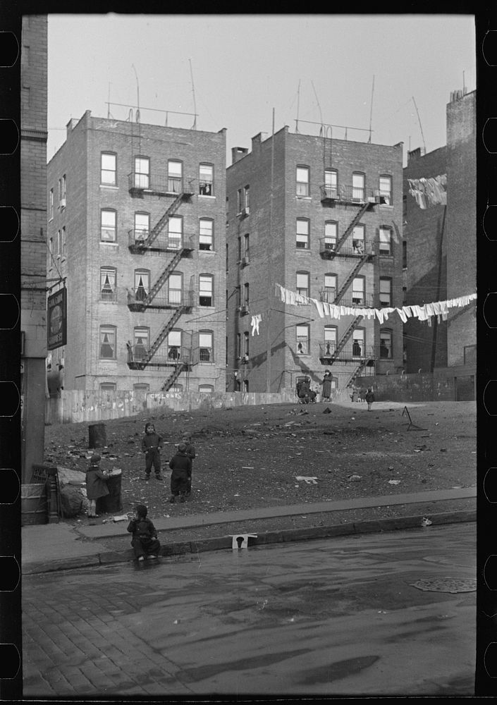 [Untitled photo, possibly related to: Apartment houses as viewed through vacant lot. In vicinity of 139th Street just east…