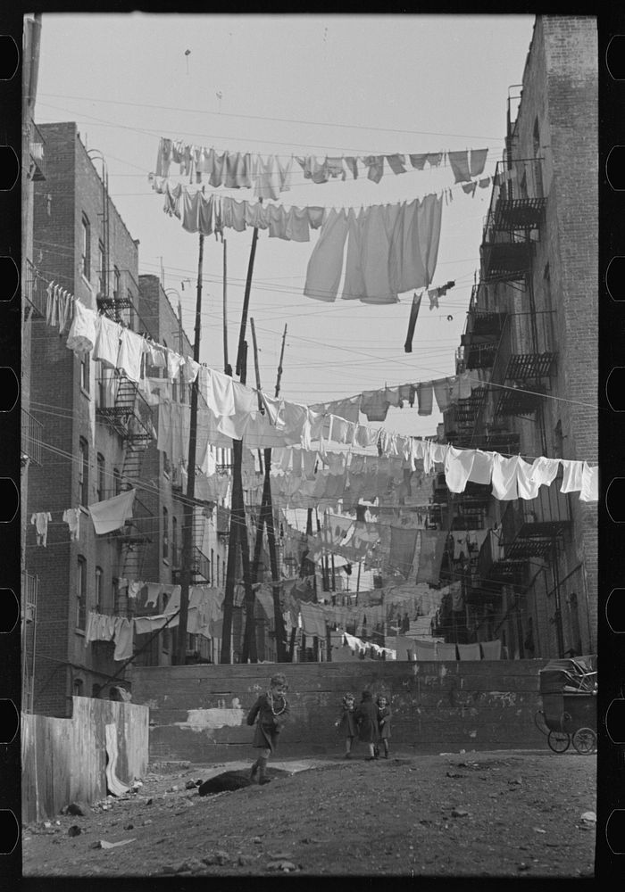 [Untitled photo, possibly related to: An avenue of clothes washings between 138th and 139th Street apartments, just east of…