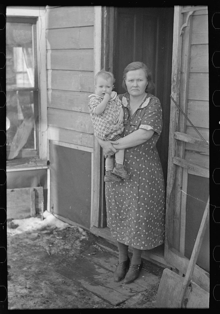 [Untitled photo, possibly related to: Mrs. Paul Rauhauser and two of her seven children in their home at Ruthven, Iowa] by…