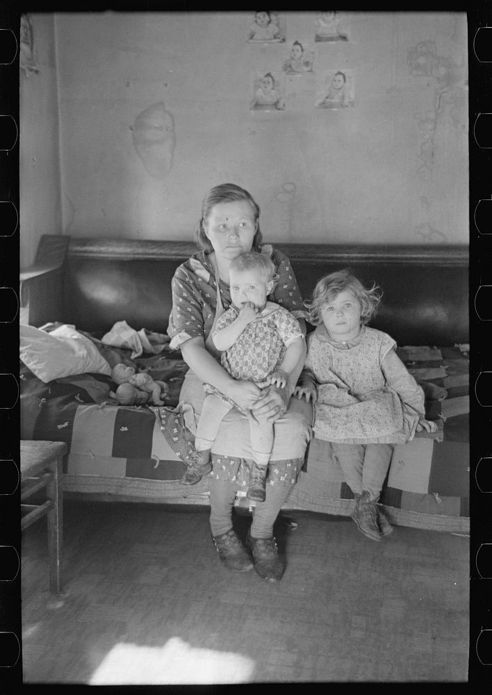 Mrs. Paul Rauhauser and two of her seven children in their home at Ruthven, Iowa by Russell Lee