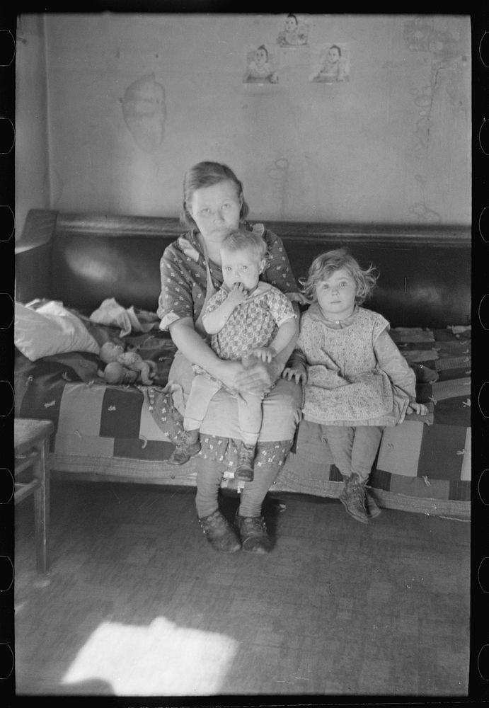 [Untitled photo, possibly related to: Mrs. Paul Rauhauser and two of her seven children in their home at Ruthven, Iowa] by…