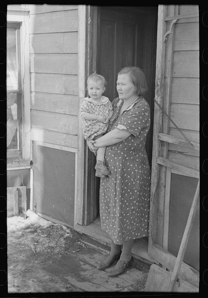 [Untitled photo, possibly related to: Mr. Rauhauser, wife and one of his seven children, Ruthven, Iowa. He works as a farm…
