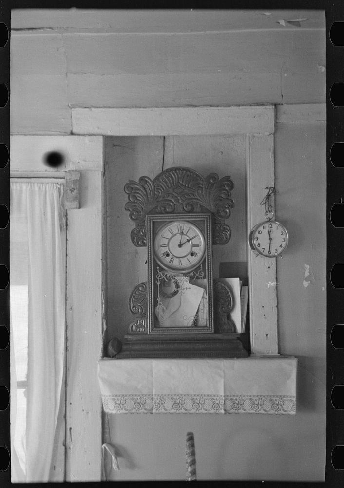 Clock in the home of John Landers, a farmer living near Marseilles, Illinois by Russell Lee