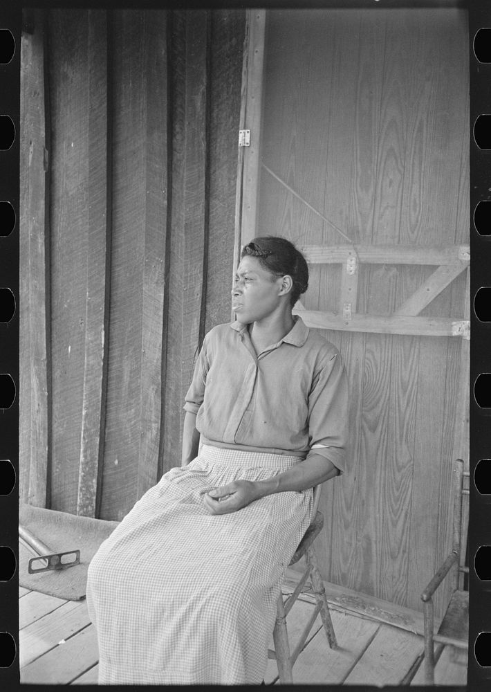 Wife of sharecropper on front porch of shack home, Southeast Missouri Farms by Russell Lee