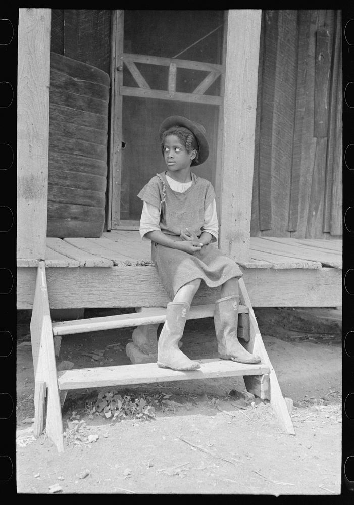 [Untitled photo, possibly related to: Daughter of sharecropper on steps of front porch, New Madrid County, Missouri] by…
