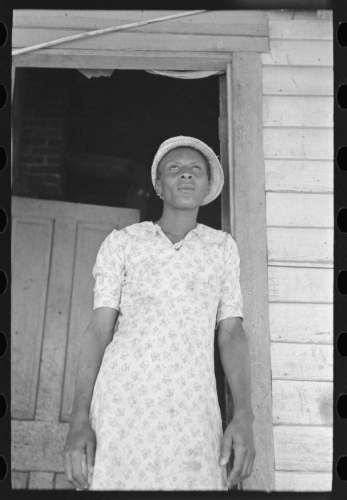[Untitled photo, possibly related to: Part of sharecropper family on porch of cabin. Note the absence of storage space] by…