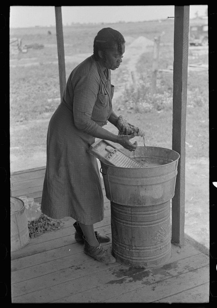 Wife of sharecropper washing clothes, Southeast Missouri Farms by Russell Lee