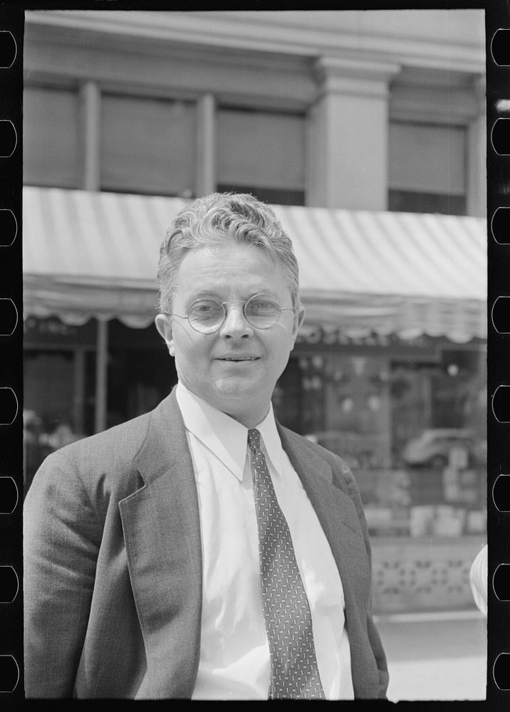 [Roy E. Stryker, photograph chief of the U.S. Farm Security Administration standing in street, probably in Washington, D.C.]…