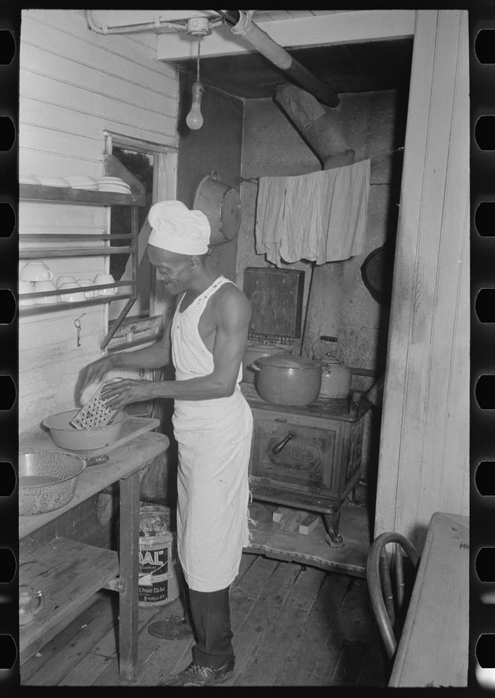 Cook of El Rito in galley of packet boat on lower Mississippi River by Russell Lee