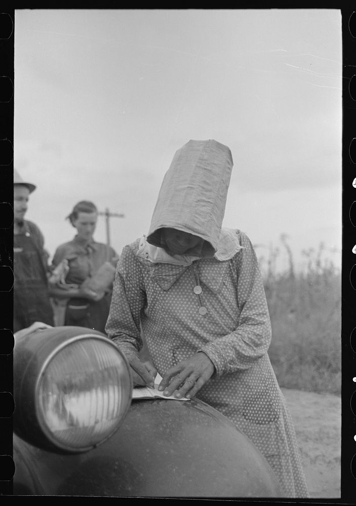 [Untitled photo, possibly related to: Woman cotton picker dragging bag of cotton, Lake Dick Project, Arkansas] by Russell Lee