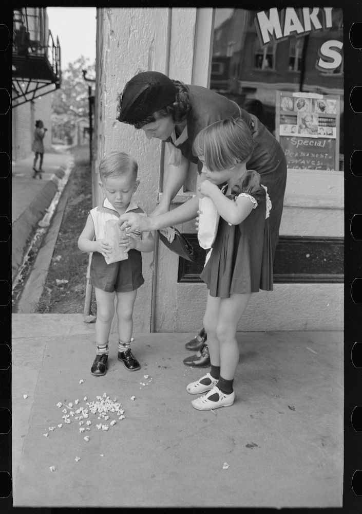 Mother with two children with popcorn, National Rice Festival, Crowley, Louisiana by Russell Lee