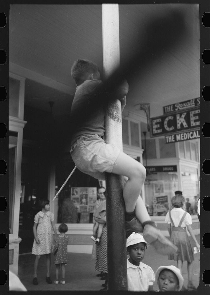 [Untitled photo, possibly related to: People standing on street corner waiting for parade, National Rice Festival, Crowley…