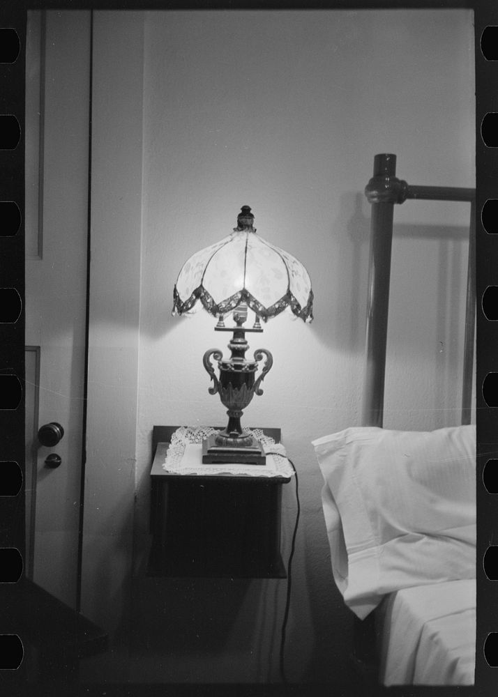 [Untitled photo, possibly related to: Bedroom with lamp in hotel at Donaldsonville, Louisiana] by Russell Lee
