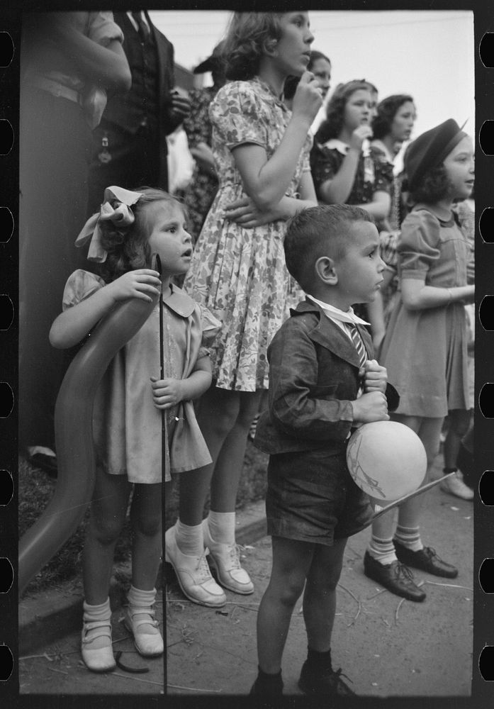 Children watching parade pass by, National Rice Festival, Crowley, Louisiana by Russell Lee