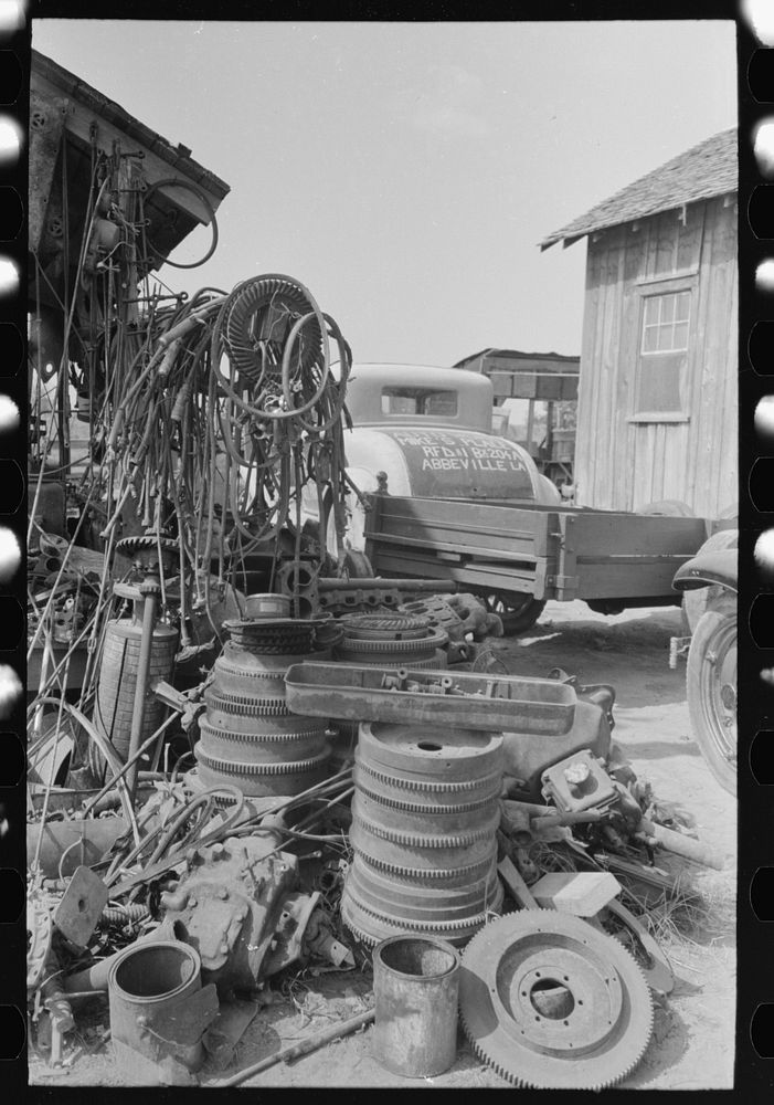 Fly wheels and speedometer cables in junkyard, Abbeville, Louisiana by Russell Lee