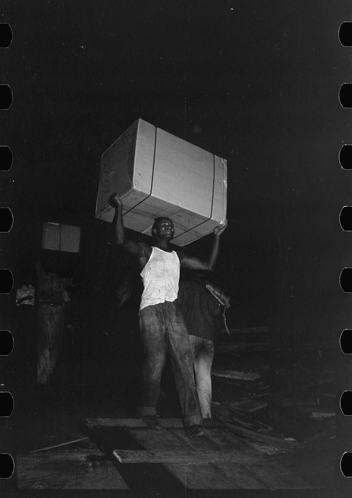 [Untitled photo, possibly related to: stevedores handling drum, New Orleans, Louisiana] by Russell Lee