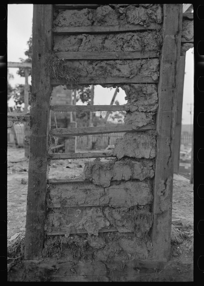 Detail of construction of old house; note the wooden cross lath. The construction material composed of mud and native moss.…