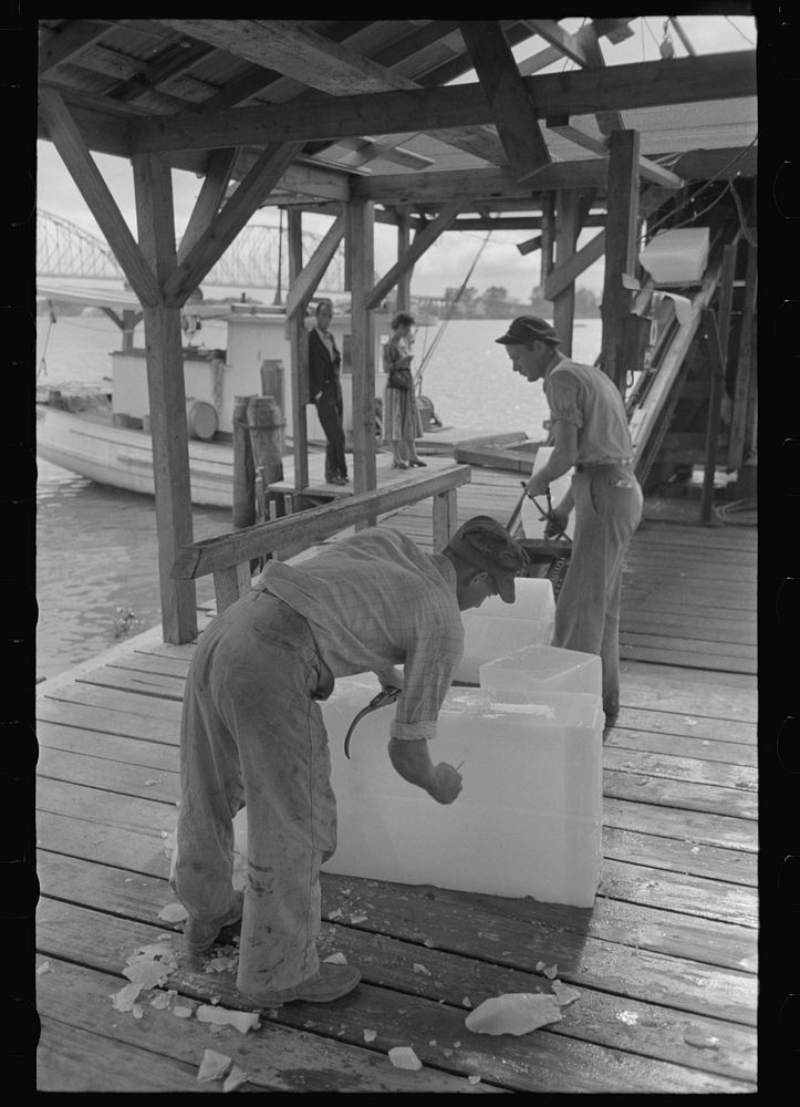 [Untitled photo, possibly related to: Chopping ice before shaving it to be used in icing shrimp boat, Morgan City…