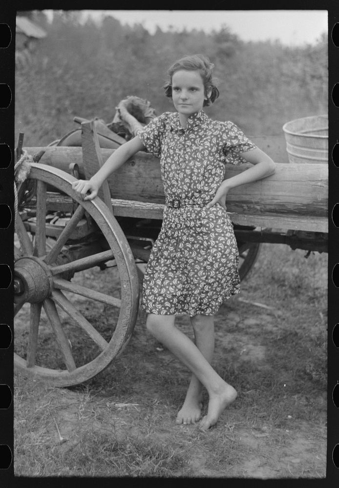 Farm girl leaning on wagon, near Morganza, Louisiana by Russell Lee