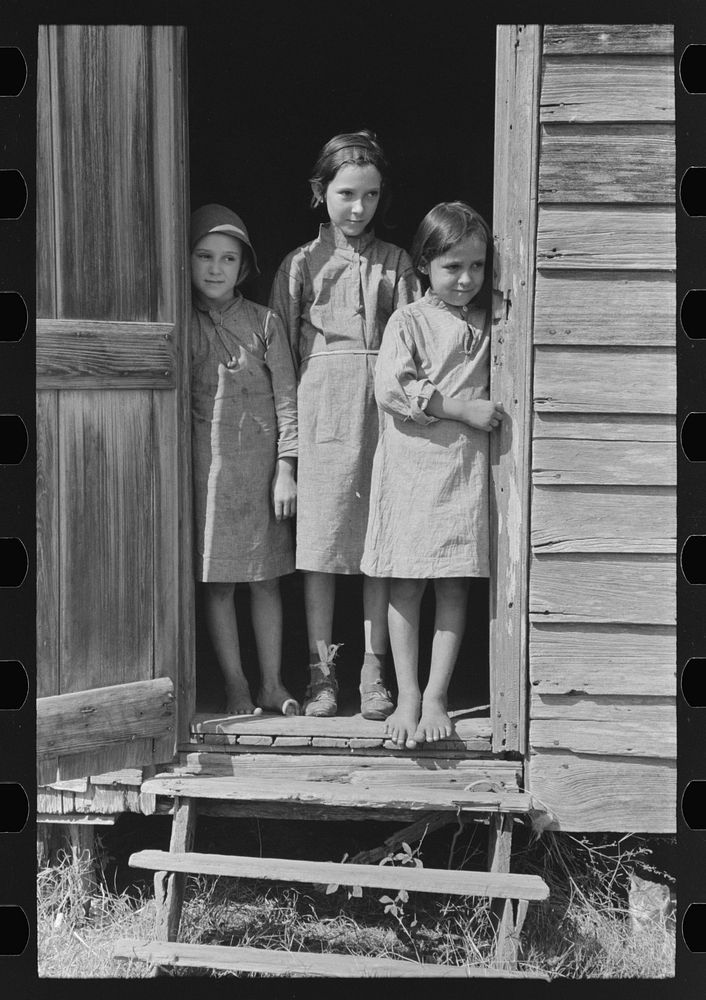 Children of day laborer in doorway of their home near New Iberia, Louisiana by Russell Lee