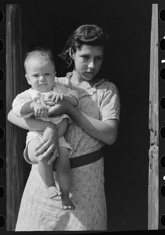 Wife and child of day laborers, sugarcane fields near New Iberia, Louisiana by Russell Lee
