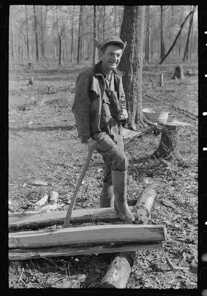 Farmer of Chicot Farms, Arkansas resting after chopping wood by Russell Lee