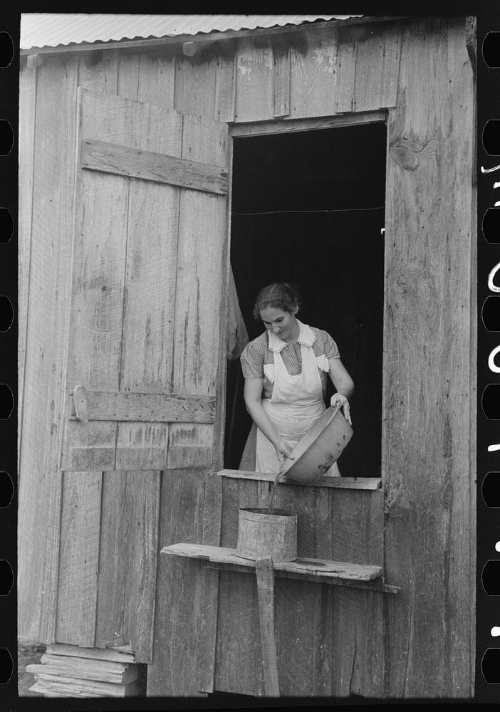 [Untitled photo, possibly related to: Wife of FSA (Farm Security Administration) client washing clothes. This family will…