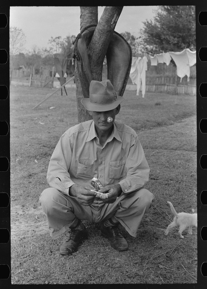 FSA (Farm Security Administration) client, sugarcane farmer, rolling cigarette, near Morganza, Louisiana by Russell Lee