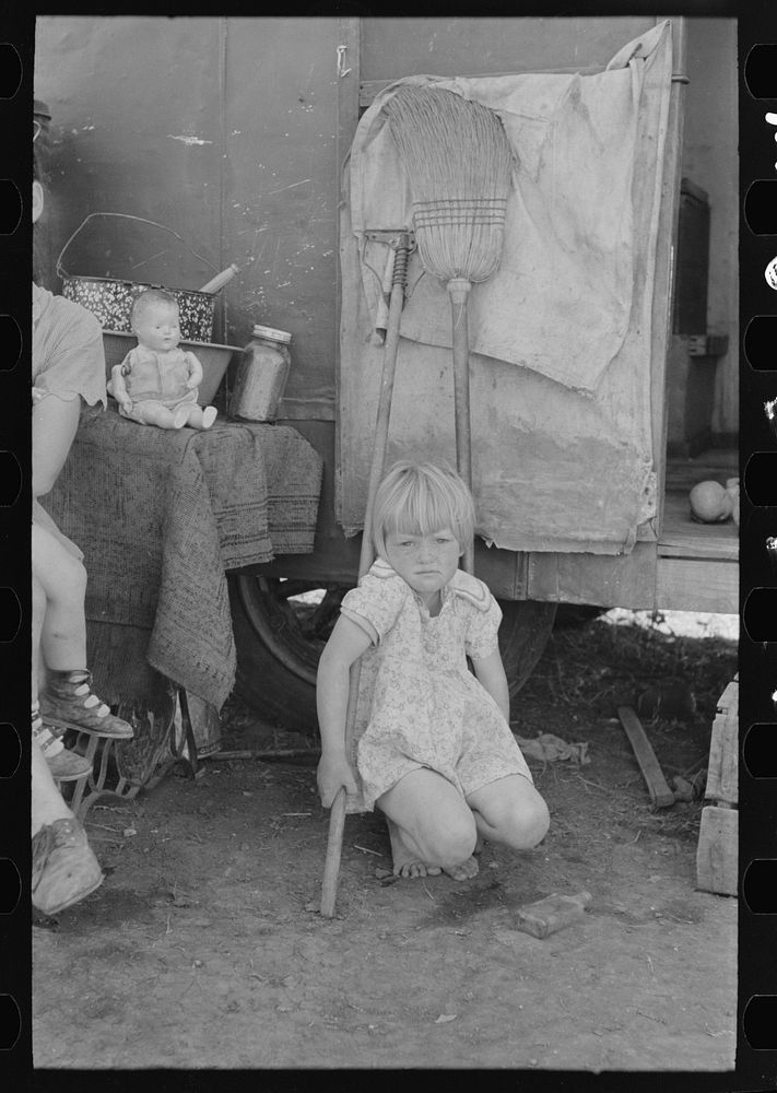 Child of white migrant worker in front of trailer home, Weslaco, Texas by Russell Lee