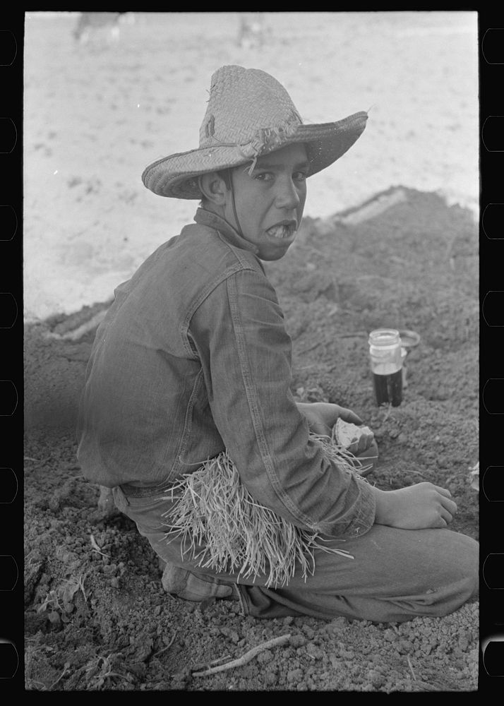 [Untitled photo, possibly related to: Young Mexican boy, carrot worker, eating "second breakfast" in field near Santa Maria…