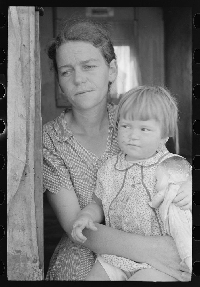 [Untitled photo, possibly related to: White migrant mother with daughter in door of trailer home near Weslaco, Texas] by…