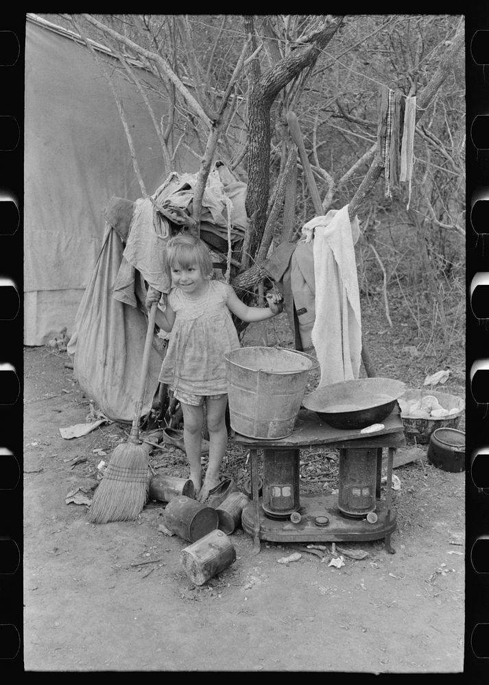 Outdoor stove, washstand and other household equipment of white migrant family near Harlingen, Texas by Russell Lee