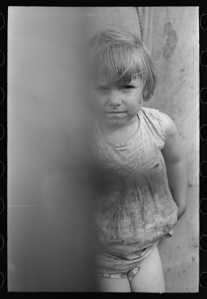 [Untitled photo, possibly related to: Child of  migrant worker standing by tent home near Harlingen, Texas] by Russell Lee