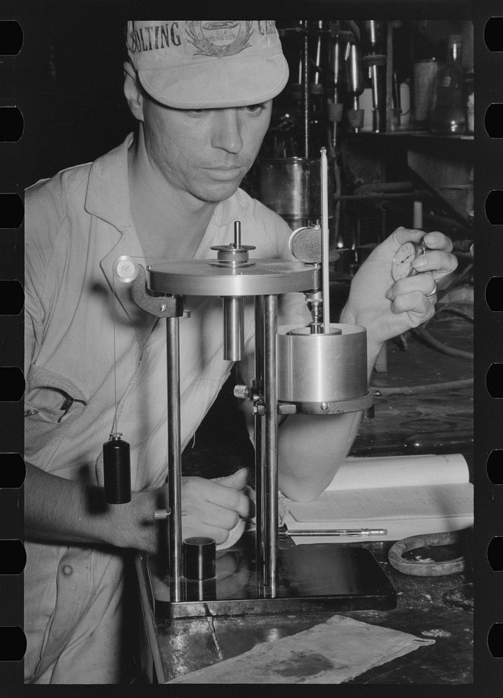 Chemist running test on sweet potato starch, Laurel, Mississippi by Russell Lee