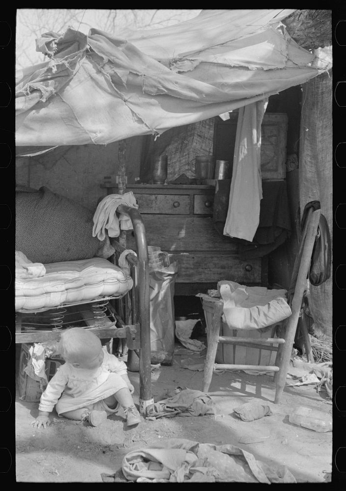 Migrant baby in front of tent, Harlingen, Texas by Russell Lee