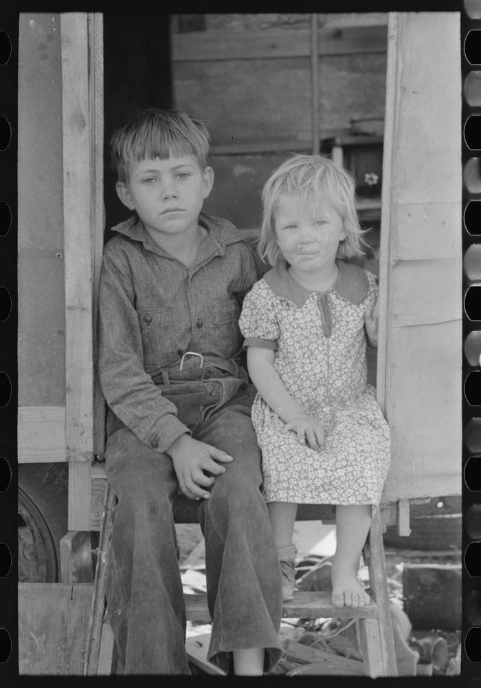 Children of migrants sitting in doorway of trailer, Edinburg, Texas by Russell Lee