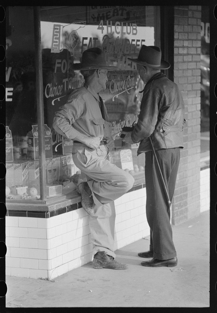 Residents of Crystal City, Texas, talking in front of grocery store by Russell Lee