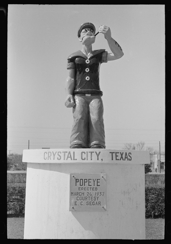 [Untitled photo, possibly related to: Monument erected to Popeye, Crystal City, Texas. This is in the spinach growing…