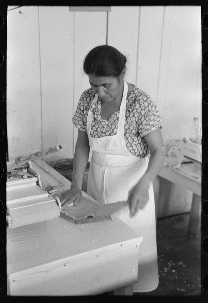 [Untitled photo, possibly related to: Mexican woman flattening and shaping tortillas between two boards hinged together, San…
