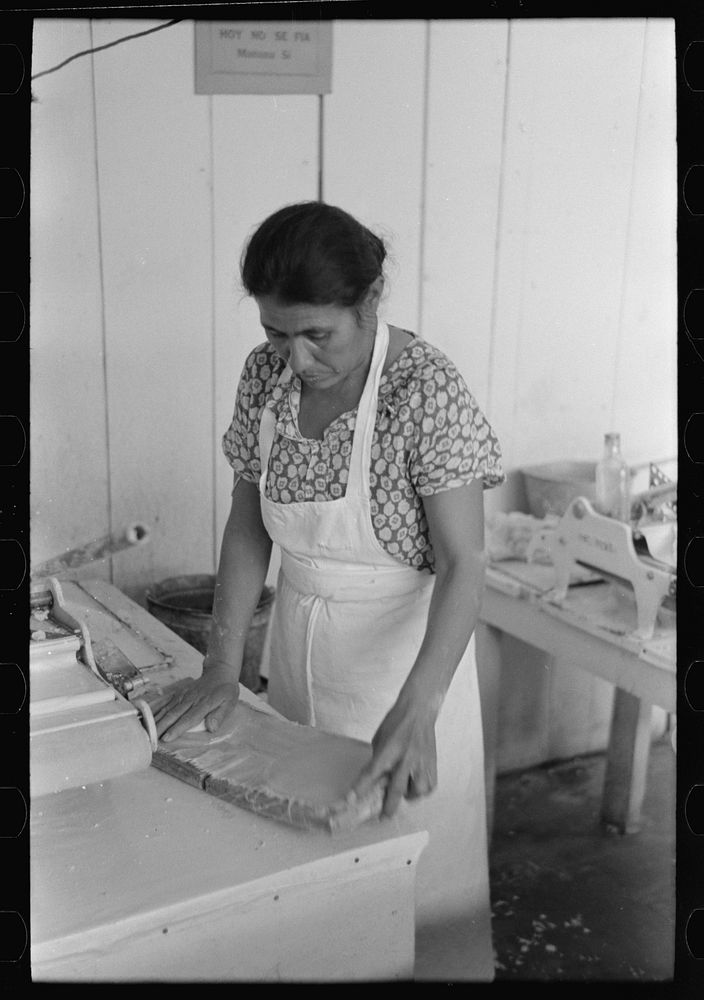 Mexican woman flattening and shaping tortillas between two boards hinged together, San Antonio, Texas by Russell Lee