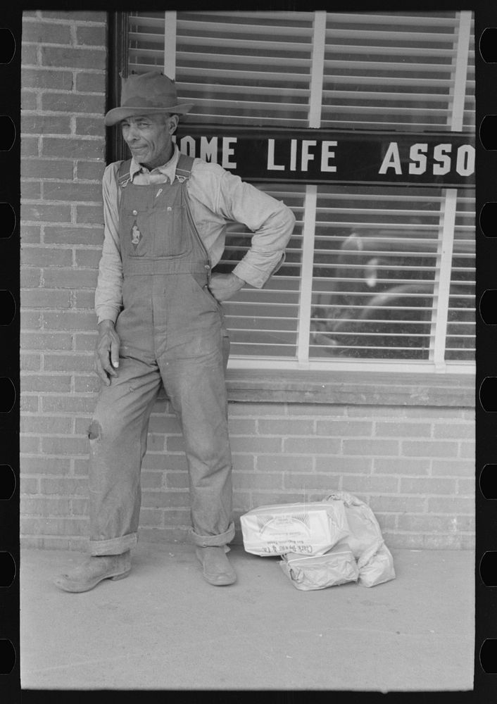 [Untitled photo, possibly related to:  farmer with supplies in town, San Augustine, Texas] by Russell Lee
