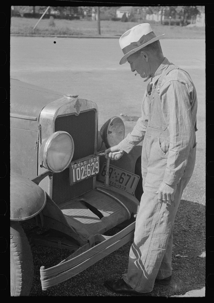 Farmer changing license plates, San Augustine, Texas by Russell Lee