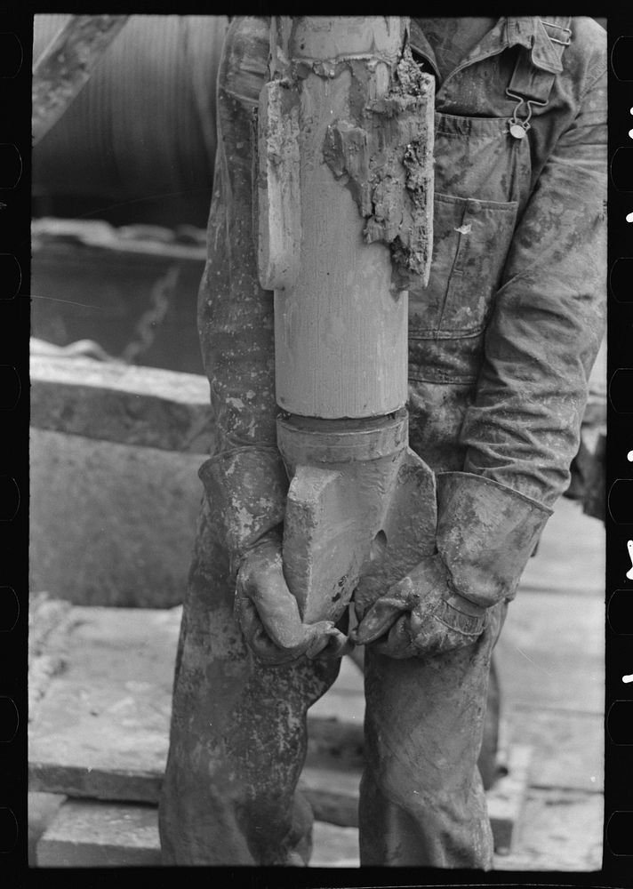Oil field worker holding bit, oil well, Kilgore, Texas by Russell Lee