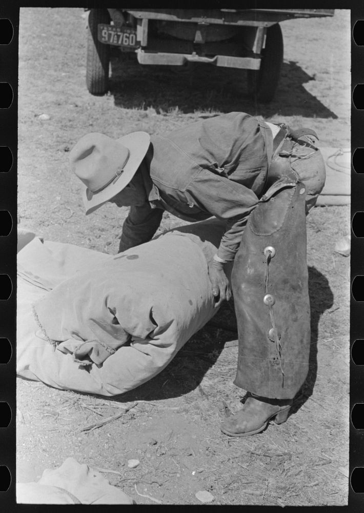[Untitled photo, possibly related to: Tying the bedroll. Bunk of the cowboy on the range. Cattle ranch near Marfa, Texas] by…