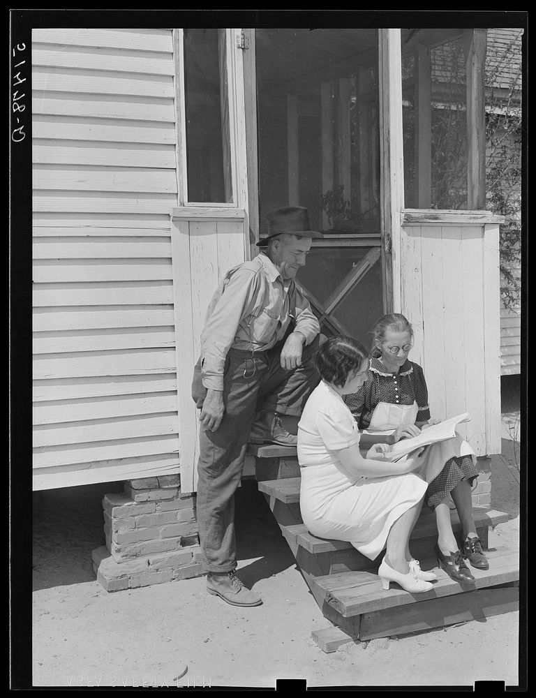 Home economist, Miss Maddox, discussing record book with Mr. And Mrs. Watkins. Coffee County, Alabama. Sourced from the…