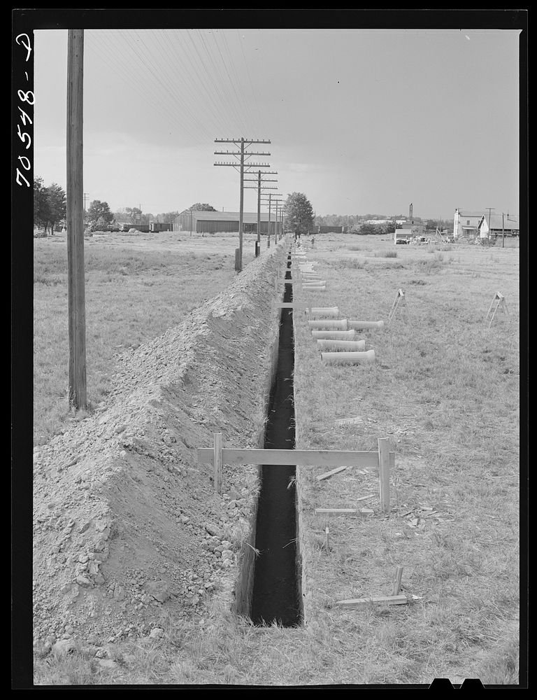 Ditch for sewer pipe at the FSA (Farm Security Administration) trailer camp for workmen at the Umatilla ordnance depot.…